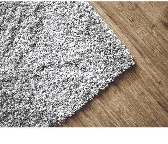 edge of carpeting on hardwood floor