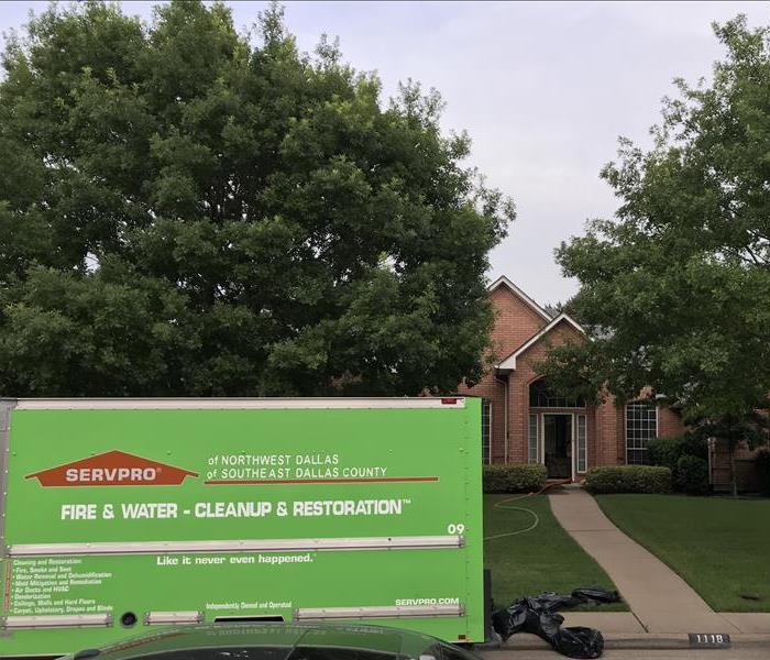 green SERVPRO box truck parked at house