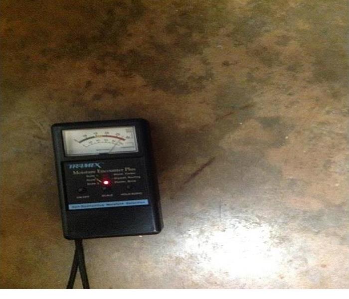 One of our moisture measurement tools sitting in the floor of a room