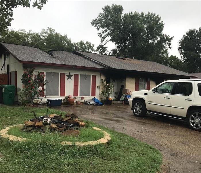 roof damage from a tree fallen during a storm.