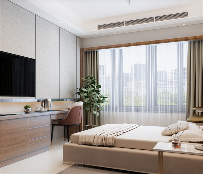 a hotel room with a bed and television