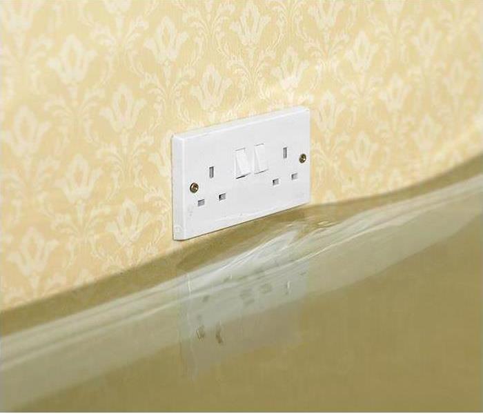 standing water on floor approaching outlet