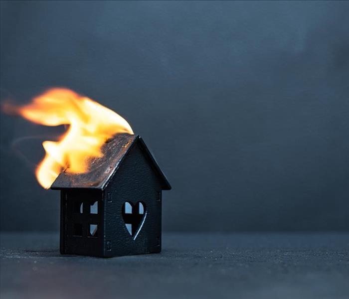 small model toy house on fire