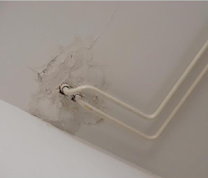 water stains on ceiling around water pipes
