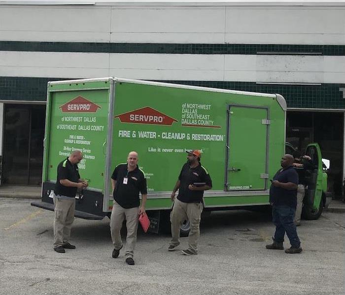 SERVPRO truck and employees in a parking lot