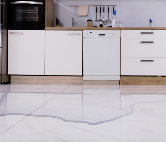 a flooded kitchen with water covering the tile